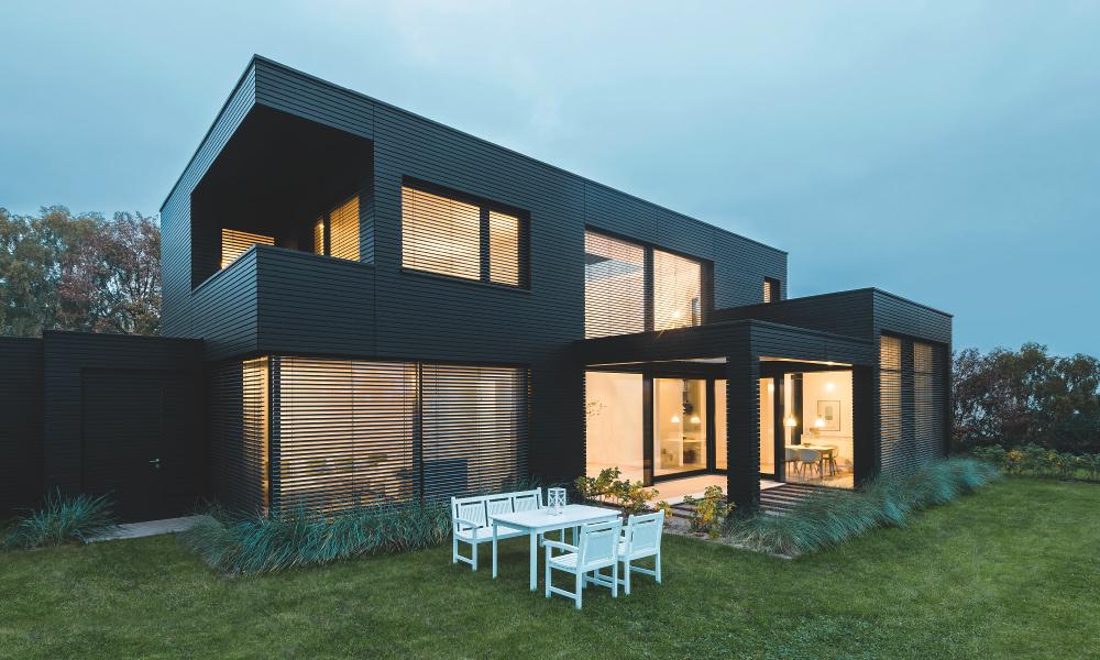 Maison moderne, au crépuscule, éclairée de l'intérieur, lame B.S.O. CDL